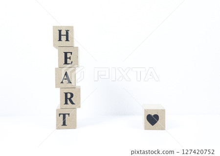 The English word HEART and a heart symbol are written on wooden blocks The English word HEART and a heart symbol are written on wooden blocks 127420752