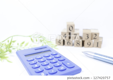 Calculator and number blocks, copy space, white background Calculator and number blocks, copy space, white background 127420757