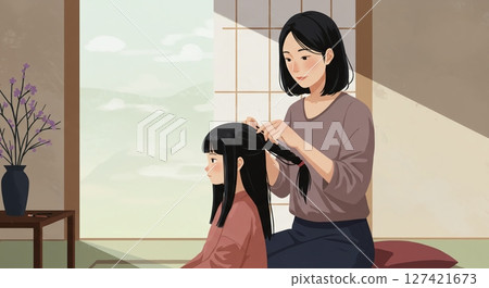 A precious moment when a mother gently ties her daughter's hair A precious moment when a mother gently ties her daughter's hair 127421673