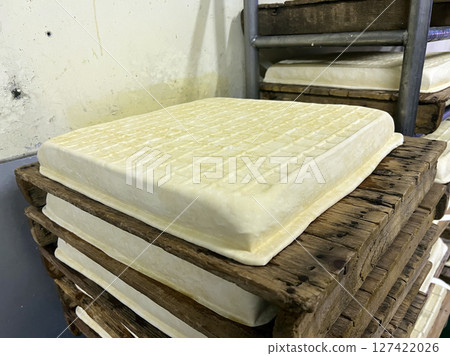 Photographing freshly made tofu in a traditional tofu shop 127422026