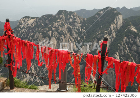 The walkway railings in the temple area have red Yantra tied to them at of Huashan Mountain is one of the most famous tourist attractions in China. The walkway railings in the temple area have red Yantra tied to them at of Huashan Mountain is one of the most famous tourist attractions in China. 127422306
