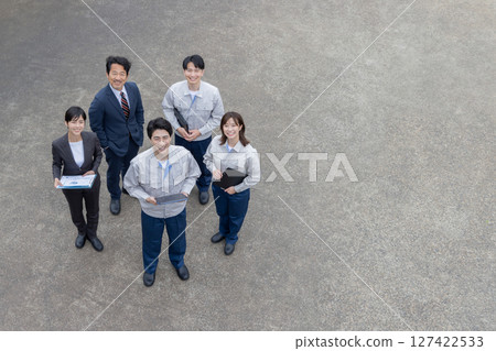 Group photo of company employees standing outside 127422533