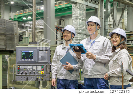 Group of workers working in a factory 127422575