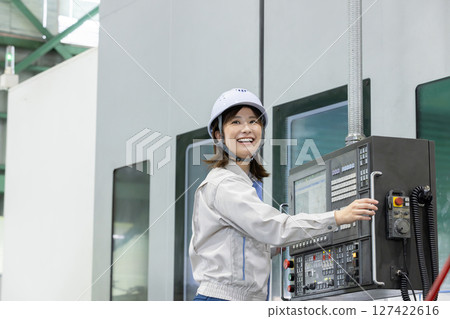 一名女工在工廠控制面板前工作 一名女工在工廠控制面板前工作 127422616