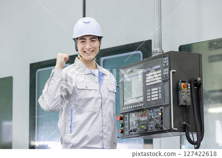 Male worker working in front of a factory control panel Male worker working in front of a factory control panel 127422618