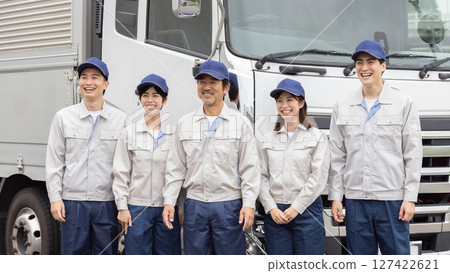A group of workers lined up in front of a truck 127422621