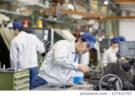 Group of workers working in a factory 127422707