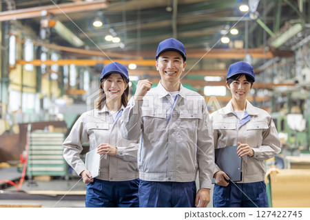 工人們在工廠揮舞拳頭 127422745