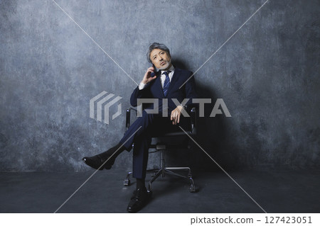 Senior businessman with a smartphone Senior businessman with a smartphone 127423051