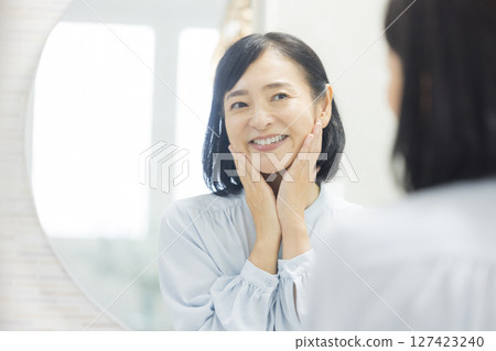 Senior woman watching a mirror Senior woman watching a mirror 127423240