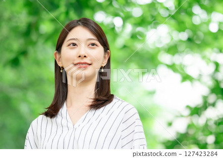 A woman smiling in the fresh green 127423284