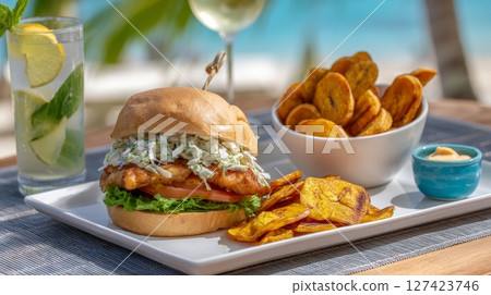 Grilled fish sandwich with slaw and plantain chips by the beach. Grilled fish sandwich with slaw and plantain chips by the beach. 127423746