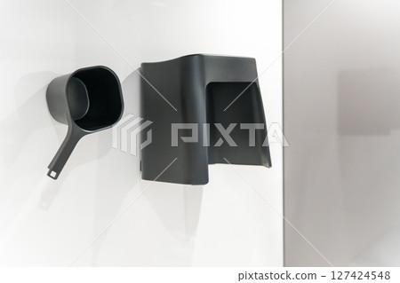 Magnetic storage chair and bucket on the bathroom wall 127424548