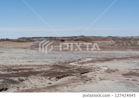 Eroded Desert Landscape at Petrified Forest National Park Under Clear Blue Sky Eroded Desert Landscape at Petrified Forest National Park Under Clear Blue Sky 127424845