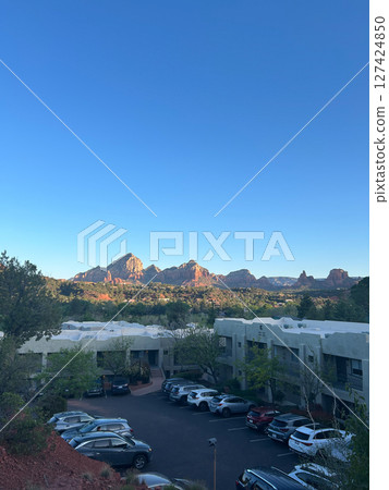 Sedona red rocks glowing at sunset over town buildings in Arizona Sedona red rocks glowing at sunset over town buildings in Arizona 127424850