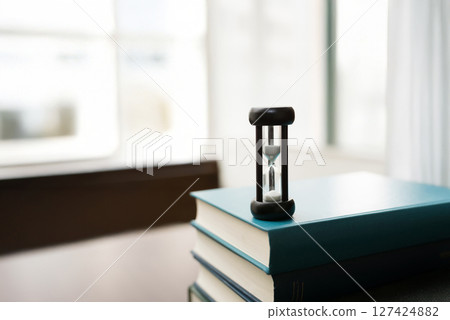 Hourglass and technical book 127424882