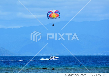Watching parasailing from a boat Watching parasailing from a boat 127425108