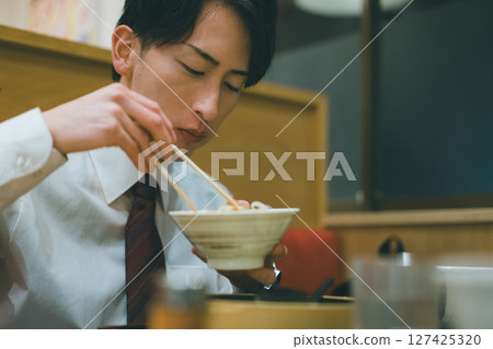 Office worker dining out at night Office worker dining out at night 127425320