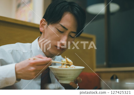 Office worker dining out at night 127425321