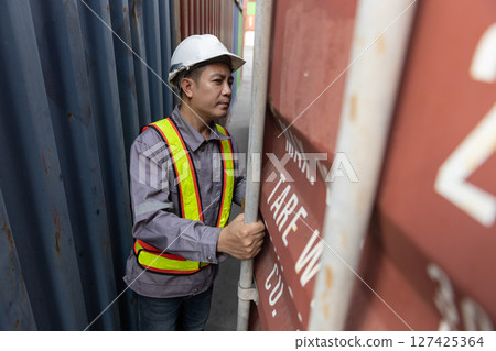 Male workers Inspect open the door check goods inside container yard port. Import and export cargo shipping industry terminal transportation. Male workers Inspect open the door check goods inside container yard port. Import and export cargo shipping industry terminal transportation. 127425364