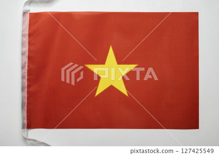 Closeup view of the Vietnam national flag isolated over a white background. Concept of government and nationality Closeup view of the Vietnam national flag isolated over a white background. Concept of government and nationality 127425549
