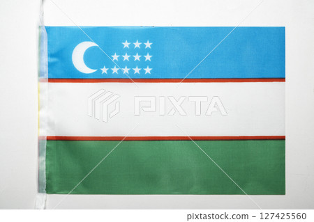 Closeup view of the Uzbekistan Republic national flag isolated over a white background. Concept of government and nationality 127425560