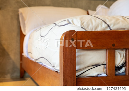 Wooden bed with soft and comfortable mattress 127425693