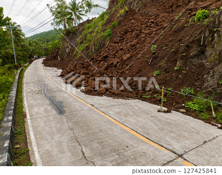 Landslides wiith rocks and soil block the highway due to heavy rainfall. Philippines. 127425841