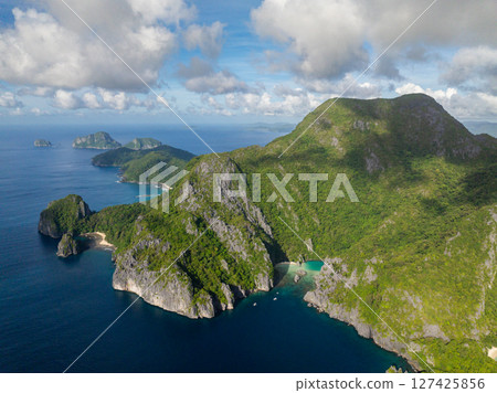 Beach and Lagoons in Cadlao Island. Blue sky and clouds. El Nido, Philippines. Beach and Lagoons in Cadlao Island. Blue sky and clouds. El Nido, Philippines. 127425856