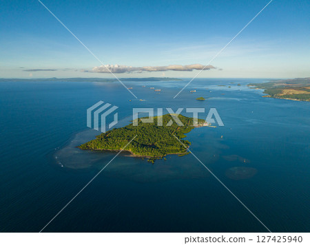 Drone view of Island surrounded by blue sea and coral reefs. Mindanao, Philippines. Seascape. 127425940