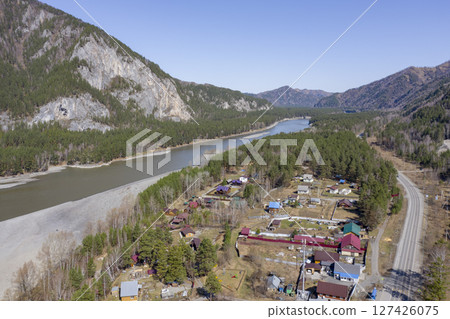 Aerial view of the village at the mountains, forest and the Katun River in the Altai Mountains Aerial view of the village at the mountains, forest and the Katun River in the Altai Mountains 127426075