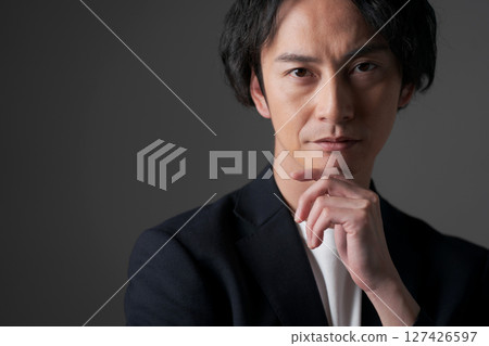 Businessman holding his chin 127426597