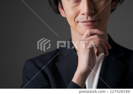 Businessman holding his chin Businessman holding his chin 127426599