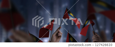 Antigua and Barbuda flags in their hands on a blurred urban background Antigua and Barbuda flags in their hands on a blurred urban background 127426610