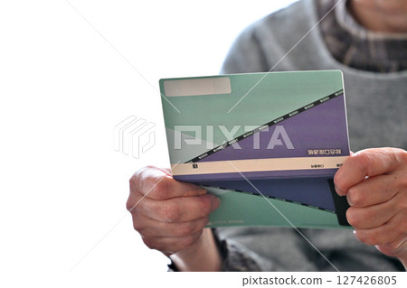Seniors checking their savings passbook Seniors checking their savings passbook 127426805