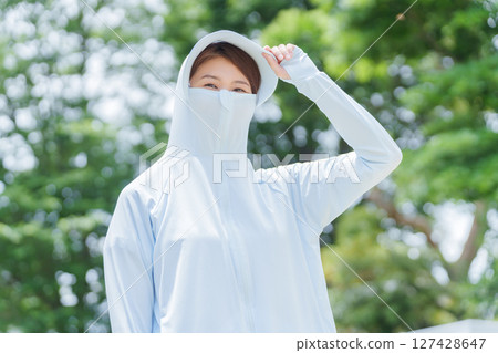 A woman wearing a rash guard to protect herself from UV rays 127428647