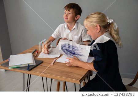 Children Drawing Classroom Education - Two children sit at a table drawing in a classroom. 127428793