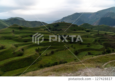 Chokhsky terraces Dagestan. Landscape of mountainous Dagestan with terraced fields and peaks mountains in the distance. Chokhsky terraces Dagestan. Landscape of mountainous Dagestan with terraced fields and peaks mountains in the distance. 127428817