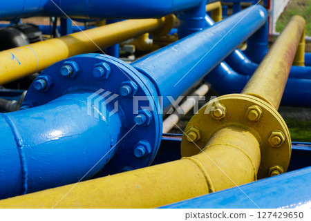 Handling Pressure Systems with Blue and Yellow Gas Pipes and Valves 127429650