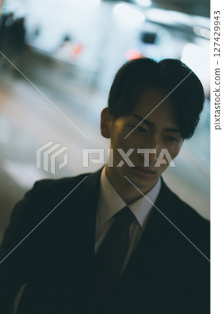 A young male business person rushing home at night A young male business person rushing home at night 127429943