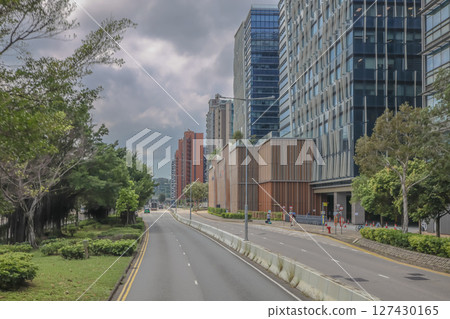 June 7 2025 Urban Street with Modern Buildings and Greenery on a Cloudy Day June 7 2025 Urban Street with Modern Buildings and Greenery on a Cloudy Day 127430165
