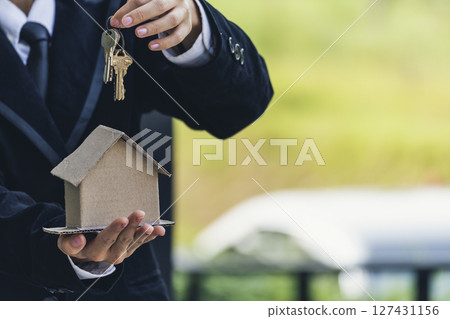 Real estate agent hands holding home business mortgage loan investment property. Hands saving protection home residential concepts. Insurance Agent sale residence ownership household protection care Real estate agent hands holding home business mortgage loan investment property. Hands saving protection home residential concepts. Insurance Agent sale residence ownership household protection care 127431156