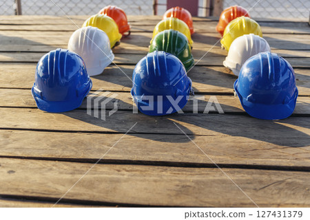 Construction hard hat safety tools equipment for workers in construction site for engineering protection head standard. Many hard hat helmet on row with copy space. Engineering Construction Concept Construction hard hat safety tools equipment for workers in construction site for engineering protection head standard. Many hard hat helmet on row with copy space. Engineering Construction Concept 127431379