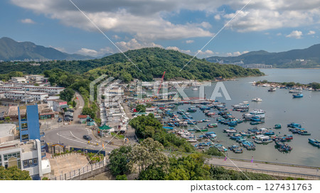 June 7 2025 Harbor View with Boats and Lush Green Hills Under Blue Sky 127431763