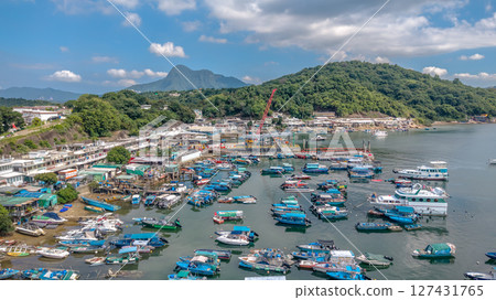 June 7 2025 Harbor View with Boats Docked and Mountainous Background Under Blue Sky 127431765