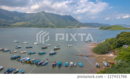 June 7 2025 Picturesque Coastal Landscape Featuring Boats and Mountains 127431766
