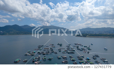 View of Floating Rafts on a Serene Lake Landscaped by Hills View of Floating Rafts on a Serene Lake Landscaped by Hills 127431779