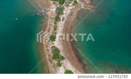 Tropical Island Coastline with Lush Forest and Turquoise Waters 127431785