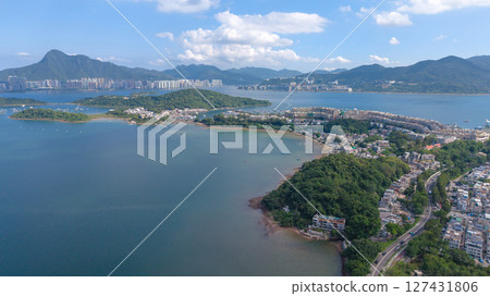 June 7 2025 A vibrant panoramic view of a serene coastal harbor, 127431806