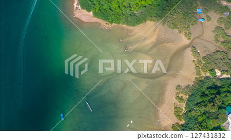 View of Coastline with Boats and Greenery in Crystal Clear Water 127431832
